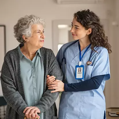 Senior Woman With Nurse Standing