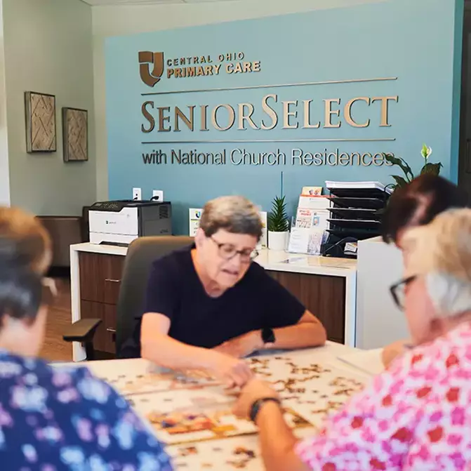 Senior select logo and women doing a puzzle